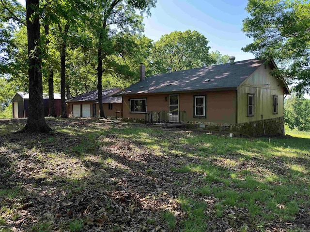 back of property with a storage unit