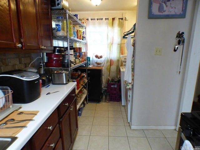 kitchen with light tile patterned floors and backsplash