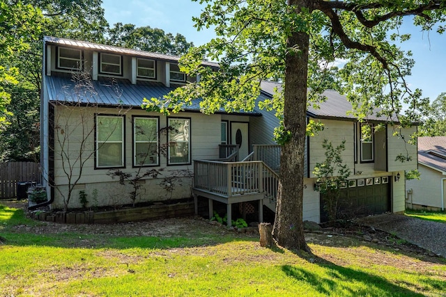 view of front facade featuring a garage, central air condition unit, and a front lawn