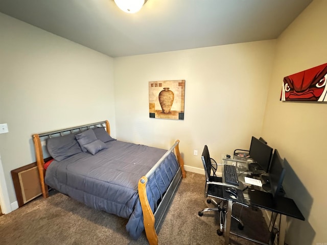 bedroom with dark colored carpet