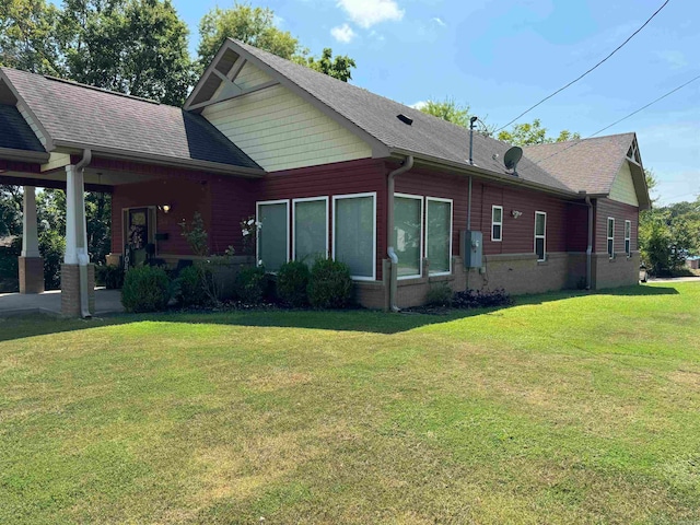 view of side of property with a yard