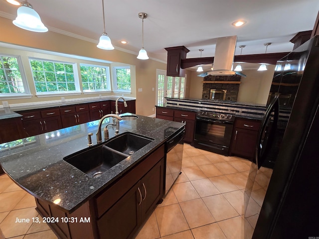 kitchen with dark stone counters, island range hood, sink, black appliances, and a center island with sink