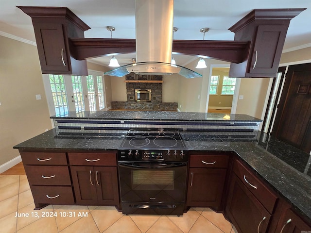 kitchen featuring island range hood, black stove, light tile patterned floors, and dark stone countertops