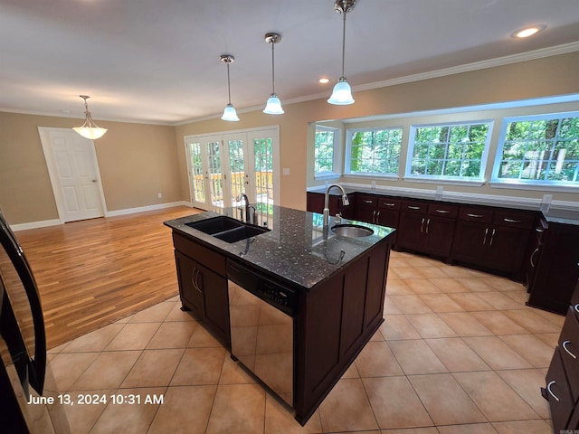 kitchen with dishwasher, light hardwood / wood-style floors, sink, and an island with sink