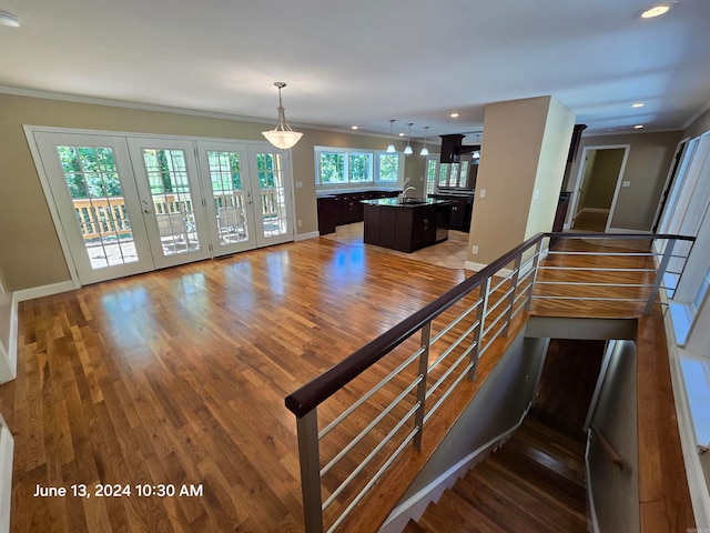 stairway featuring hardwood / wood-style floors, french doors, and ornamental molding