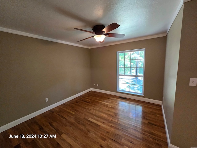 spare room with ceiling fan, dark wood-type flooring, a textured ceiling, and ornamental molding