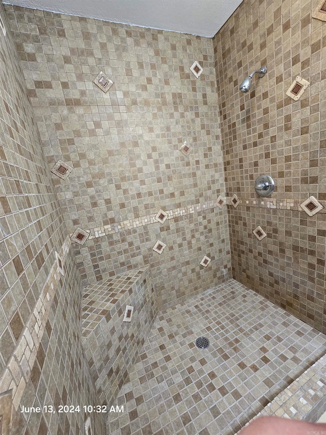 bathroom with tiled shower