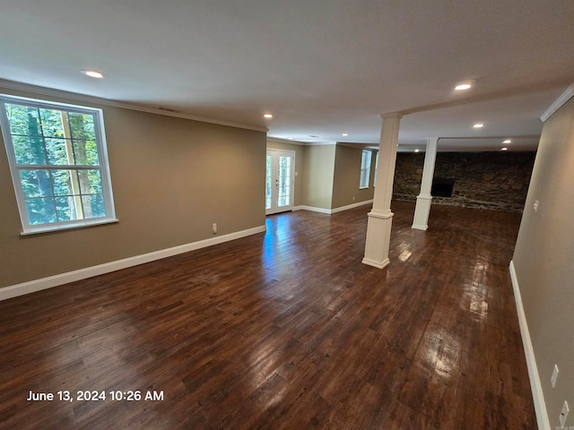 basement featuring dark wood-type flooring and ornamental molding