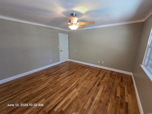 spare room with dark hardwood / wood-style flooring, ceiling fan, and crown molding