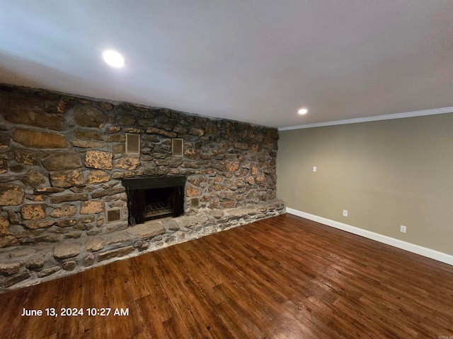 unfurnished living room featuring crown molding, wood-type flooring, and a fireplace