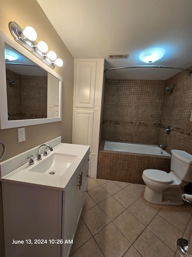 full bathroom with tile patterned flooring, vanity, toilet, and tiled shower / bath combo