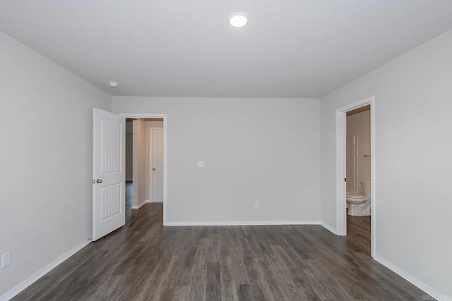 empty room with dark hardwood / wood-style flooring