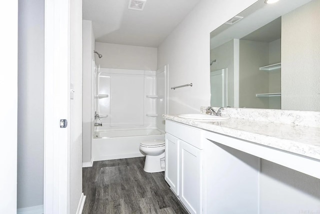 full bathroom featuring hardwood / wood-style floors, vanity,  shower combination, and toilet