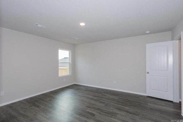 empty room featuring dark wood-type flooring