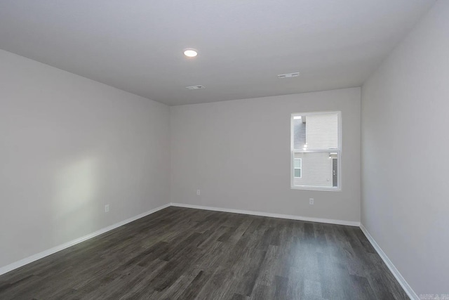 spare room featuring dark hardwood / wood-style flooring