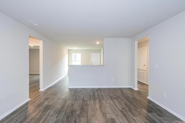 spare room featuring dark hardwood / wood-style floors