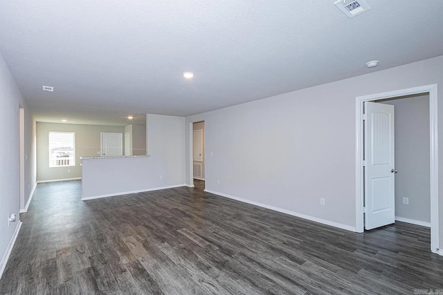 unfurnished living room featuring dark wood-type flooring