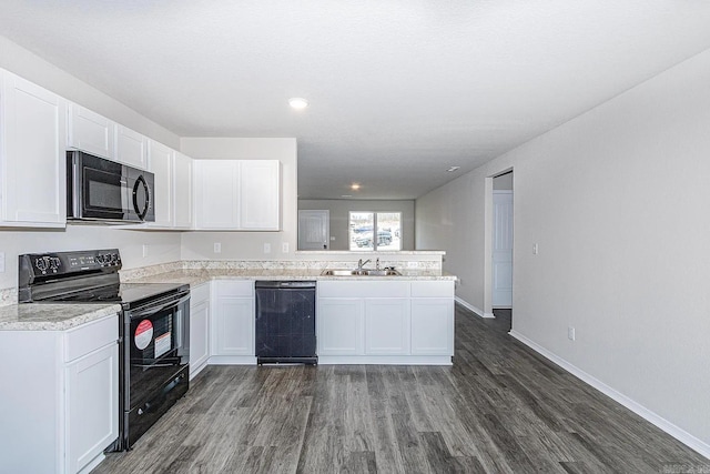 kitchen featuring kitchen peninsula, sink, black appliances, white cabinets, and dark hardwood / wood-style floors