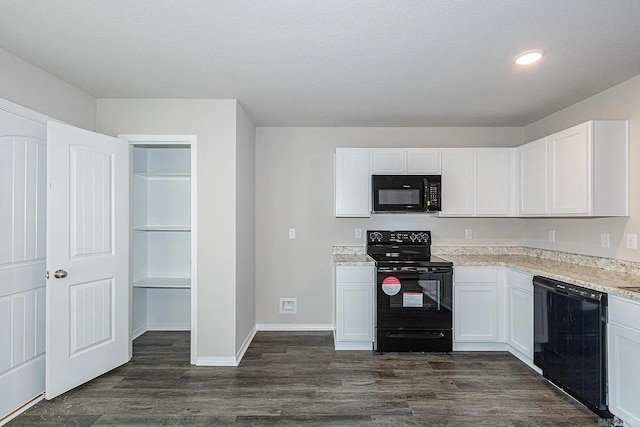 kitchen featuring white cabinetry, black appliances, and dark hardwood / wood-style floors