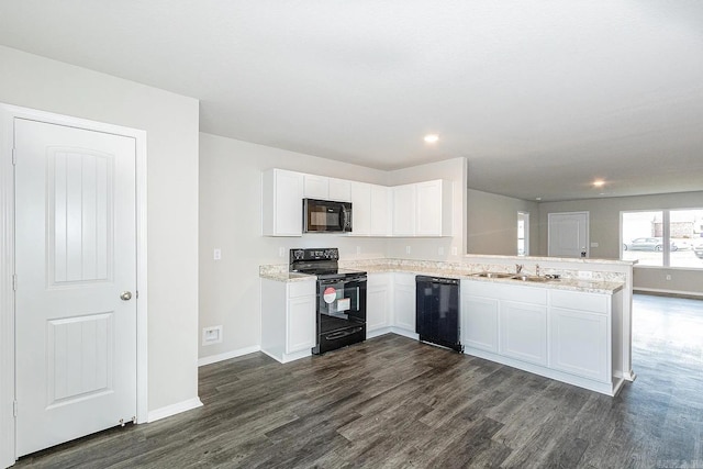 kitchen featuring kitchen peninsula, white cabinets, black appliances, and dark hardwood / wood-style floors