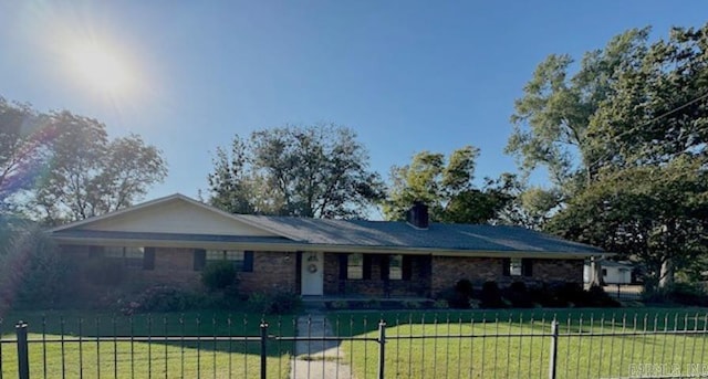 ranch-style home with a front lawn