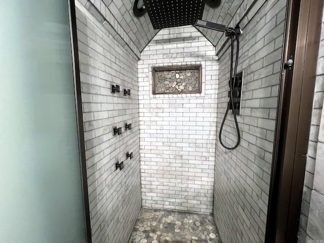 bathroom with tiled shower