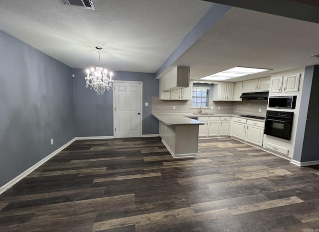 kitchen with pendant lighting, built in microwave, black oven, dark hardwood / wood-style flooring, and white cabinetry