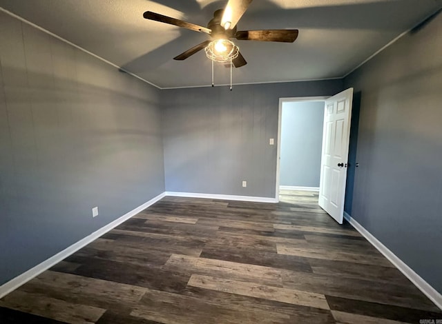 empty room with ceiling fan and dark wood-type flooring