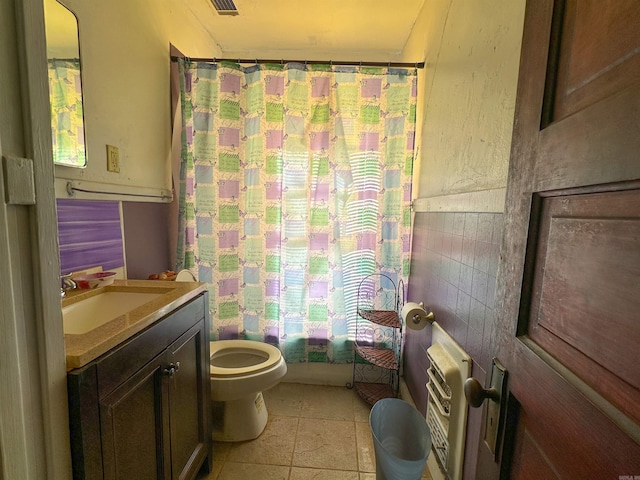 full bathroom featuring tile patterned flooring, vanity, toilet, and shower / bath combo with shower curtain