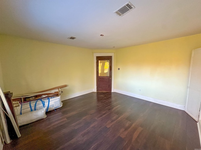 spare room with dark wood-type flooring