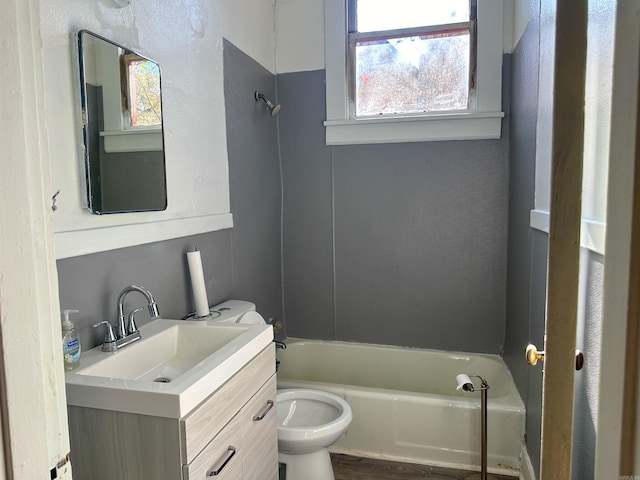 full bathroom with vanity, wood-type flooring, tub / shower combination, and toilet