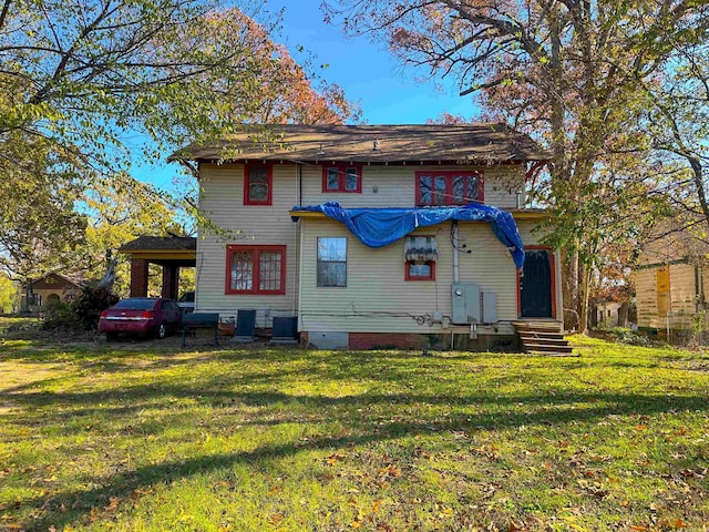 back of house featuring a yard and central air condition unit