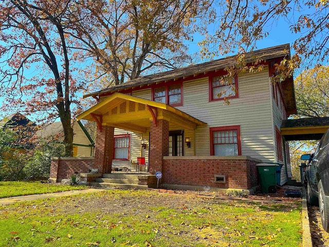 view of front facade with a front yard and covered porch