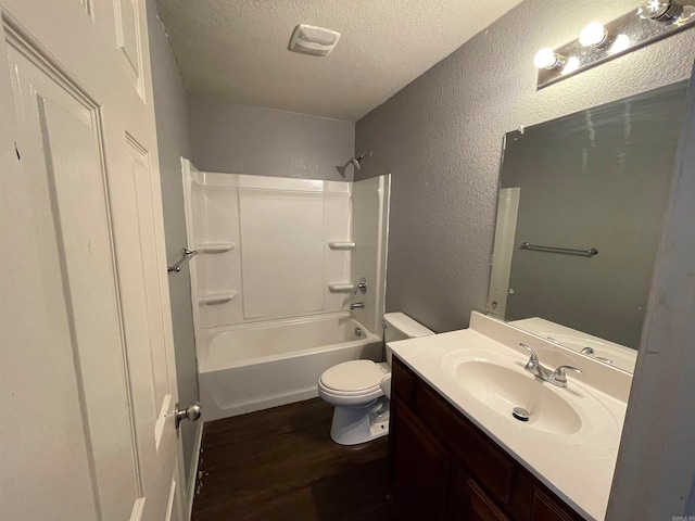 full bathroom featuring hardwood / wood-style floors,  shower combination, a textured ceiling, toilet, and vanity