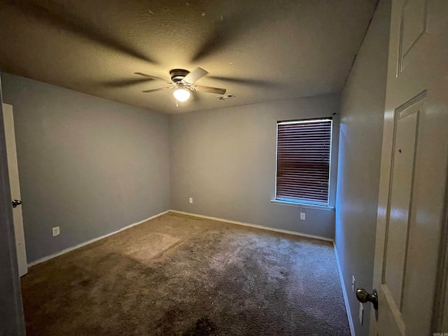 carpeted spare room with a textured ceiling and ceiling fan