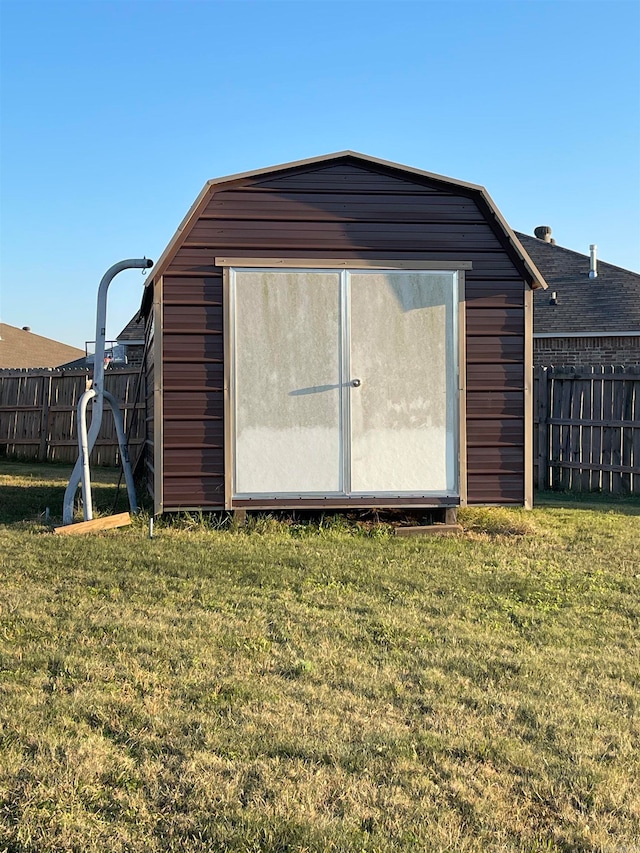 view of outbuilding featuring a lawn