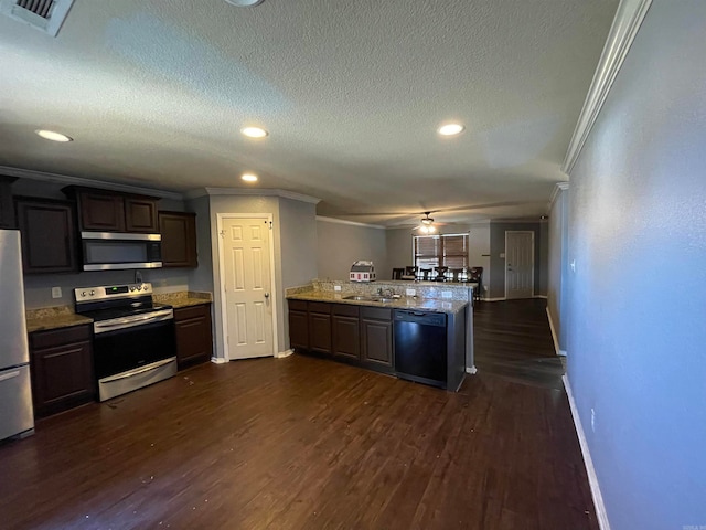 kitchen featuring dark brown cabinetry, dark hardwood / wood-style flooring, and stainless steel appliances