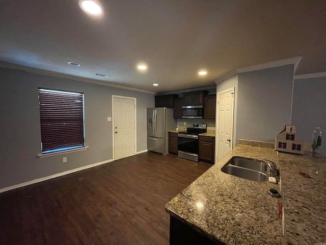 kitchen with dark hardwood / wood-style flooring, light stone counters, stainless steel appliances, crown molding, and sink