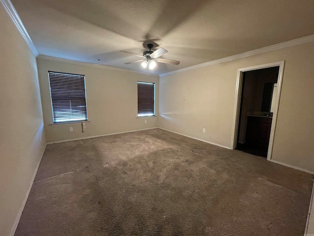 carpeted empty room with ceiling fan, plenty of natural light, and ornamental molding