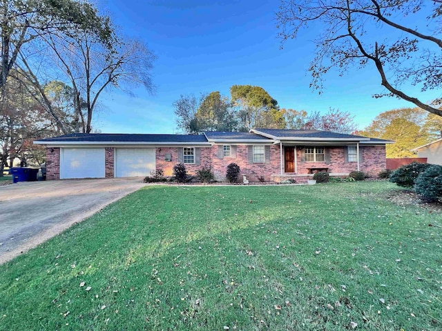 ranch-style house featuring a garage and a front lawn