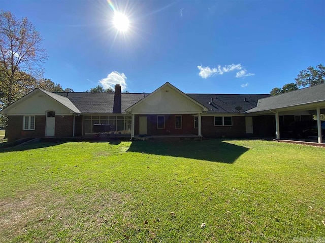 rear view of house with a yard