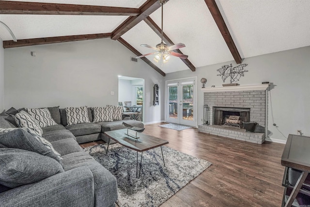 living room featuring dark wood-type flooring, high vaulted ceiling, french doors, ceiling fan, and a fireplace