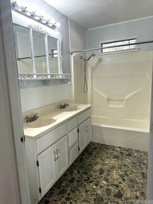 bathroom featuring vanity, a textured ceiling, and tub / shower combination