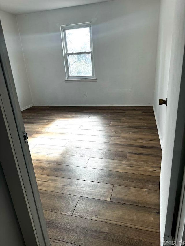 spare room featuring dark hardwood / wood-style floors