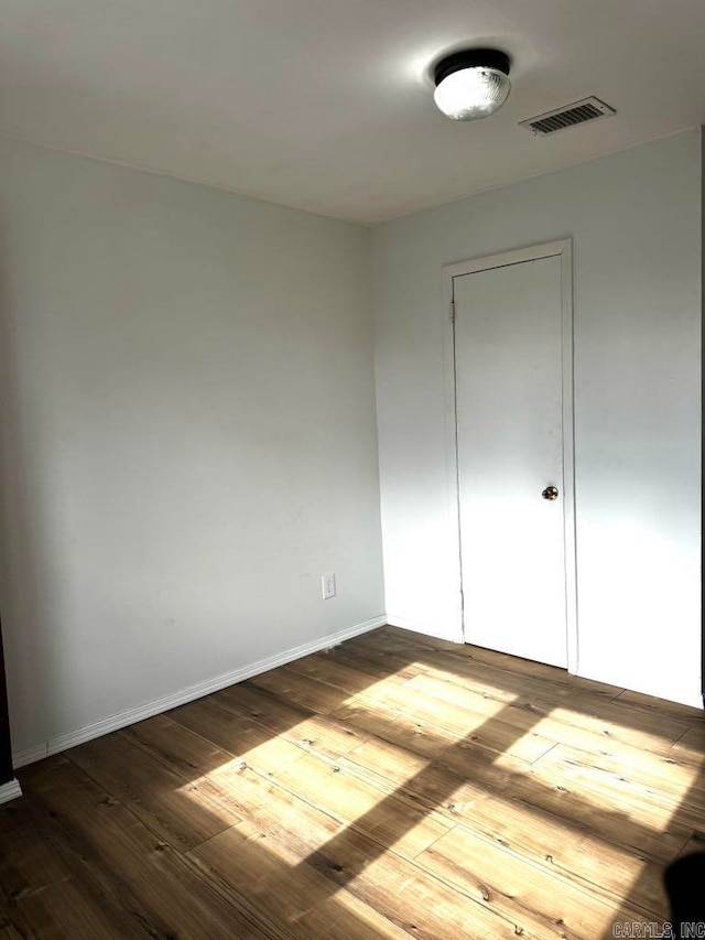 unfurnished room with hardwood / wood-style floors