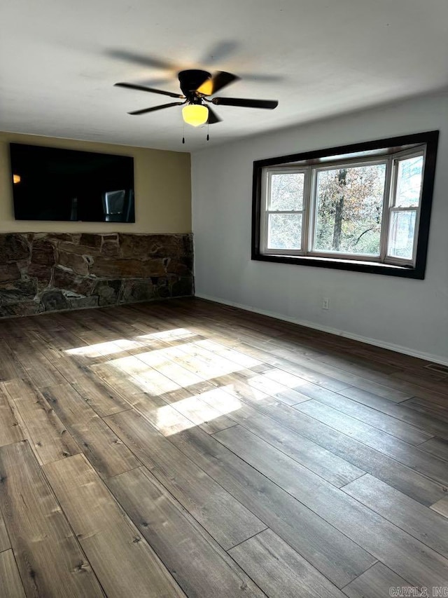 unfurnished room with ceiling fan and hardwood / wood-style floors