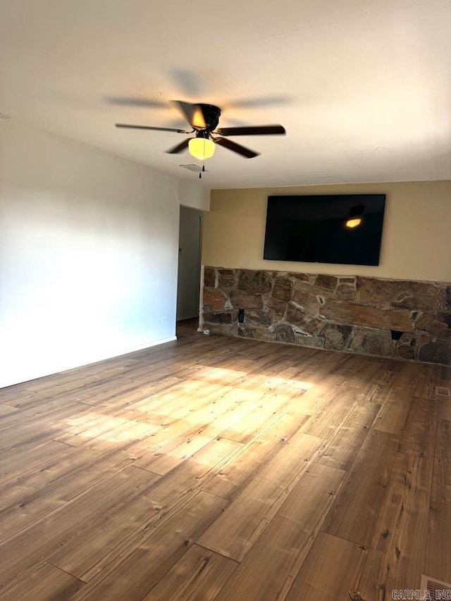 empty room featuring ceiling fan and hardwood / wood-style floors