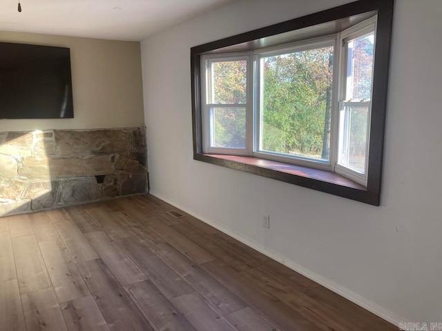 empty room with hardwood / wood-style floors