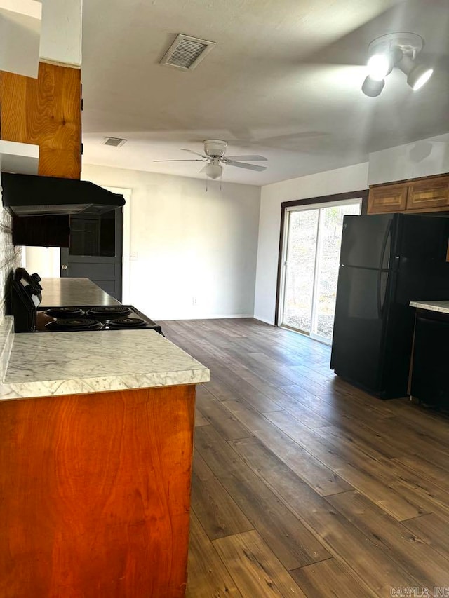 kitchen featuring ceiling fan, dark wood-type flooring, and black appliances