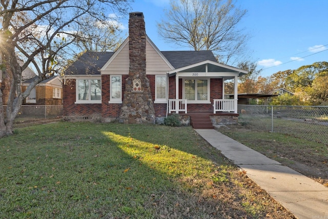 bungalow-style home with covered porch and a front yard